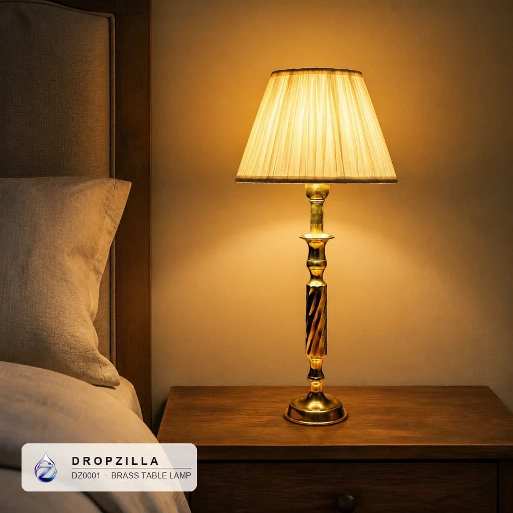 A brass table lamp glowing on a bedside